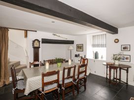 A dining room with a table and chairs at Bryn Tegid in Beaumaris