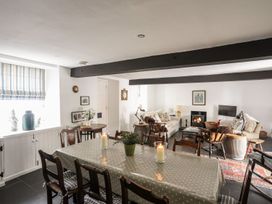 A dining room with a table and chairs at Bryn Tegid in Beaumaris