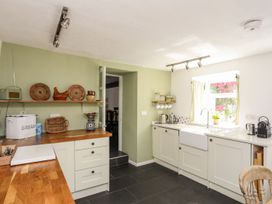 A kitchen with cabinets and a sink at Bryn Tegid in Beaumaris