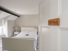 A bedroom with a bed and a bedside table at Bryn Tegid in Beaumaris