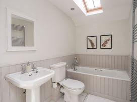 A bathroom with a bathtub and sink at Bryn Tegid in Beaumaris