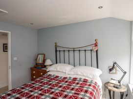 A bedroom with a bed and chest of drawers at Bryn Tegid, Beaumaris