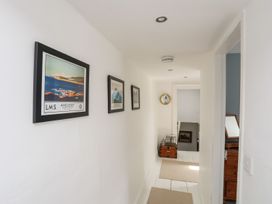 A hallway with pictures on the wall at Bryn Tegid Beaumaris