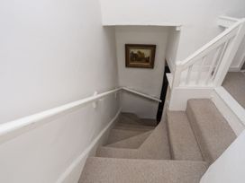 A staircase with a painting on the wall at Bryn Tegid Beaumaris