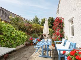 An outdoor area with a blue table and chairs at Bryn Tegid in Beaumaris