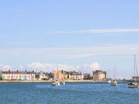 A view of boats and houses along the water at Bryn Tegid in Beaumaris