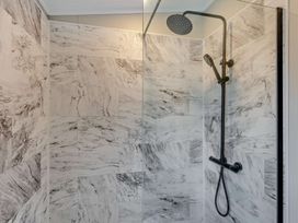 A shower with tiles and fixtures at Saron 2.0 Spa Pet, Llandyrnog