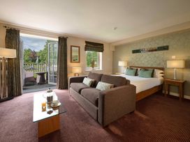 A bedroom with a sofa and a bed at Fell View Apartment in Penrith