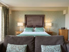 A bedroom with a bed and bedside tables at Fell View Apartment in Penrith