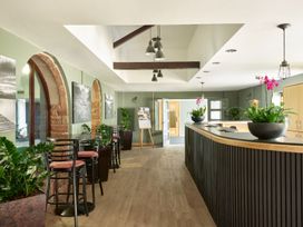 A lobby with a reception desk and plants at Fell View Apartment in Penrith