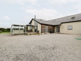 A house with a patio and outdoor seating at Cae Sam in Pentraeth