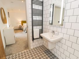 A bathroom with a sink and towel rack at Cae Sam in Pentraeth