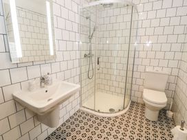 A bathroom with a shower, toilet and sink at Cae Sam in Pentraeth