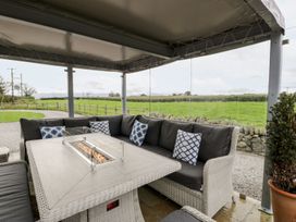 An outdoor seating area with a sofa and table at Cae Sam in Pentraeth