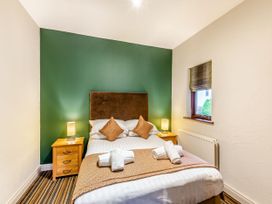 A bedroom with a bed and bedside tables at Skiddaw in Penrith