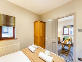 A bedroom with a bed and wardrobe at Skiddaw in Penrith