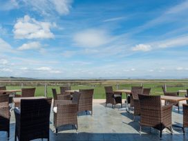An outdoor seating area with tables and chairs at Skiddaw in Penrith