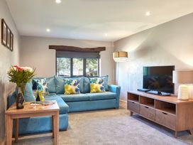 A living room with a sofa and TV at Derwent in Penrith
