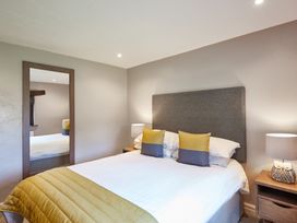 A bedroom with a bed and bedside tables at Derwent in Penrith