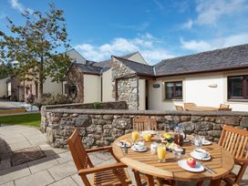An outdoor dining area with a table set for breakfast at Derwent (Pet) Penrith