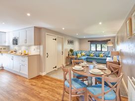 An open plan living dining area with kitchen and seating at Derwent (Pet) Penrith