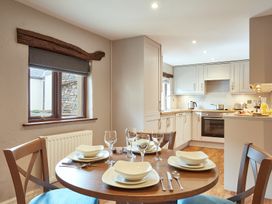 A kitchen with a dining table set at Derwent (Pet) Penrith