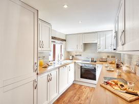 A kitchen with appliances and food items at Derwent (Pet) Penrith