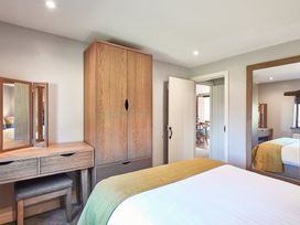 A bedroom with a bed and wardrobe at Derwent (Pet) in Penrith