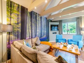 A living room with a sofa and chairs at The Whitbarrow Den in Penrith