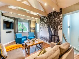 A living room with a tv and coffee table at The Whitbarrow Den Penrith