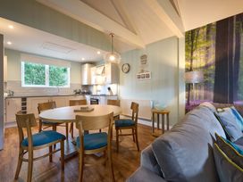 A kitchen with a dining table and chairs at The Whitbarrow Den in Penrith