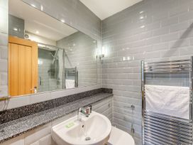 A bathroom with a sink and mirror at The Whitbarrow Den in Penrith