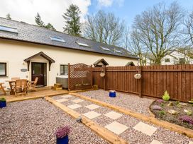 A garden with seating and a hot tub at Caldew Cottage Spa in Penrith