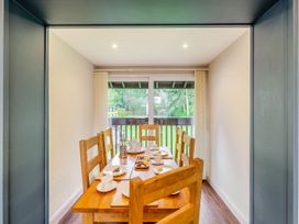A dining room with a table set for tea at Caldew Cottage Spa in Penrith
