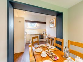 A dining room with a table set for tea and cookies at Caldew Cottage Spa Penrith