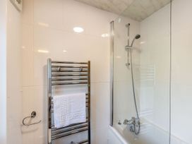 A bathroom featuring a bathtub and shower at Caldew Cottage Spa in Penrith
