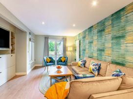A living room with a sofa and chairs by a window at The Troutbeck Den Spa in Penrith
