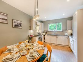 A kitchen with a dining table set for a meal at The Troutbeck Den Spa Penrith
