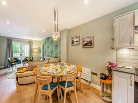 A dining room with table and chairs at The Troutbeck Den Spa Penrith
