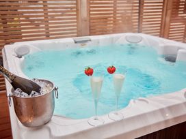 A hot tub with champagne and strawberries at The Farmhouse 2 in Penrith