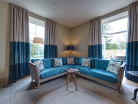 A living room with a sofa and curtains at The Farmhouse 2 Penrith