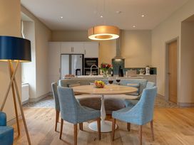 A kitchen with a table and chairs at The Farmhouse 2 in Penrith