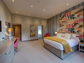 A bedroom with a bed and desk at The Farmhouse 2 Penrith