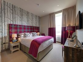 A bedroom with a double bed and bedside lamps at The Farmhouse 2 in Penrith