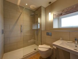 A bathroom with a shower cubicle and a sink at The Farmhouse 2 Penrith