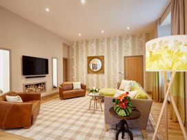 A living room with a sofa and armchair at The Farmhouse 1 in Penrith