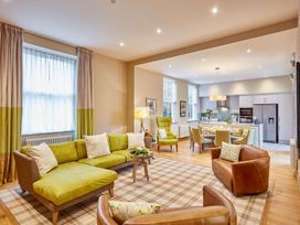 A living room with a sofa and armchairs at The Farmhouse 1 in Penrith