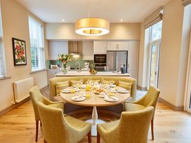 A kitchen with dining area and modern appliances at The Farmhouse 1 Penrith
