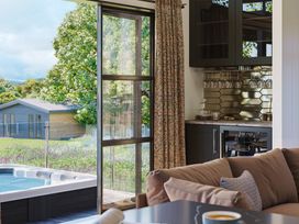 A living room with a hot tub and kitchen area at Peak View in Penrith