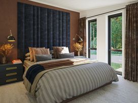 A bedroom with a bed and bedside table at Peak View in Penrith